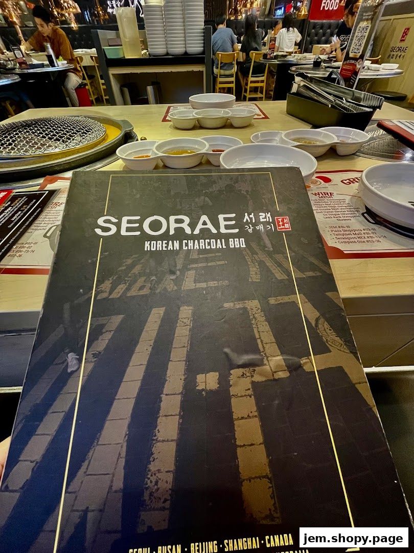 A menu for SEORAE Korean Charcoal BBQ with various dipping sauces and grill setup.