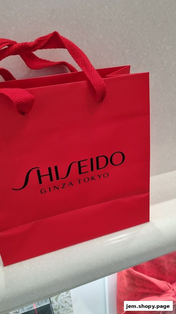 A red Shiseido shopping bag with 'GINZA TOKYO' text and red handles.