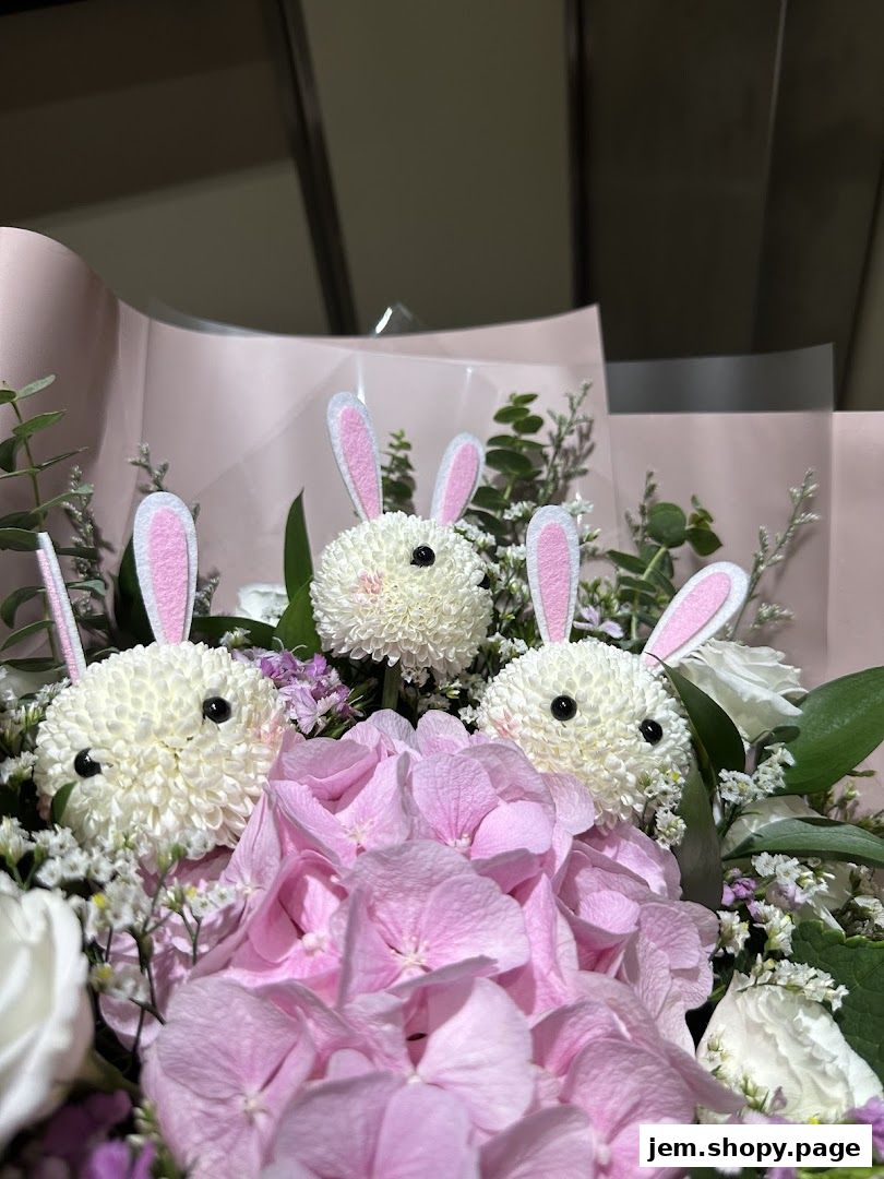 A bouquet of flowers featuring three adorable bunny-shaped floral arrangements.