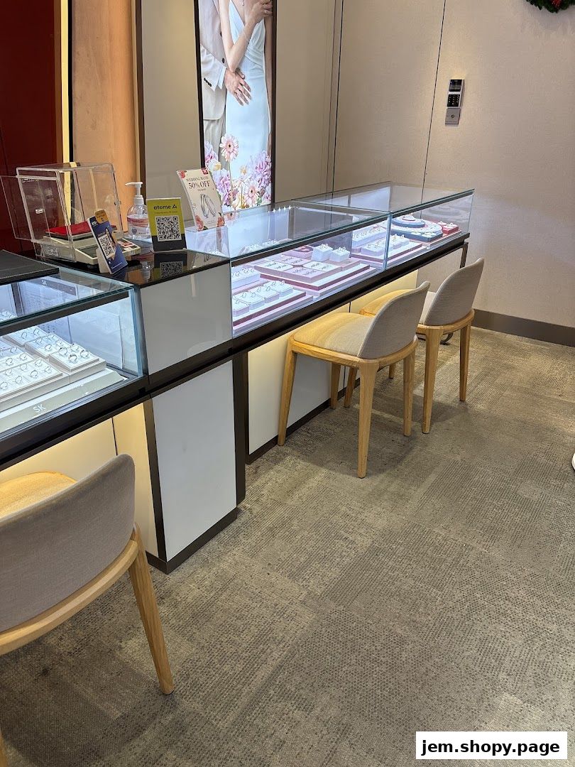 Interior view of a jewelry store with display cases filled with jewelry and seating.
