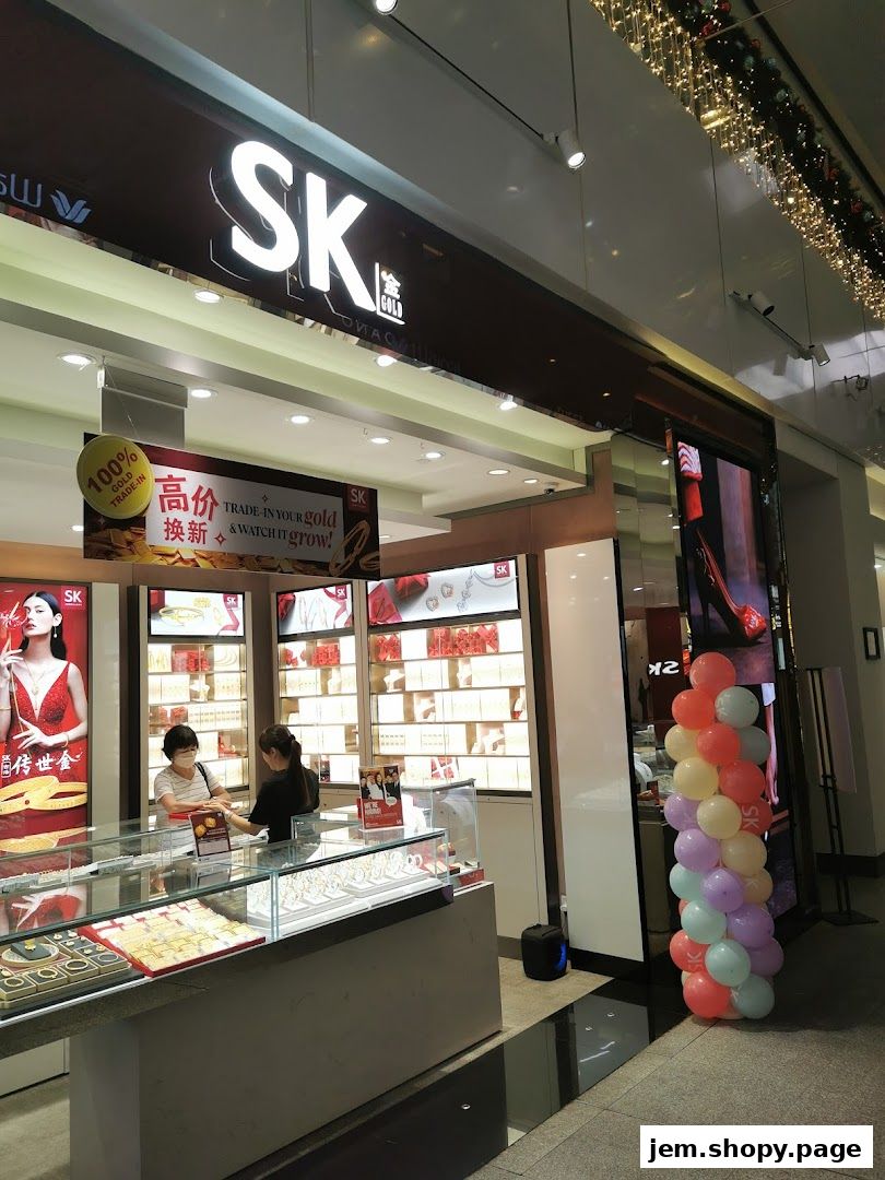 SK Gold JEM jewelry store front with displays of gold jewelry and staff assisting a customer.