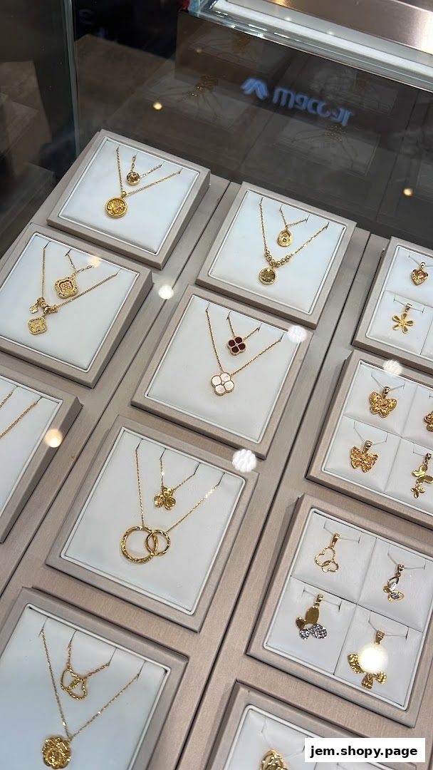 Display of elegant gold necklaces and pendants in a jewelry store showcase.