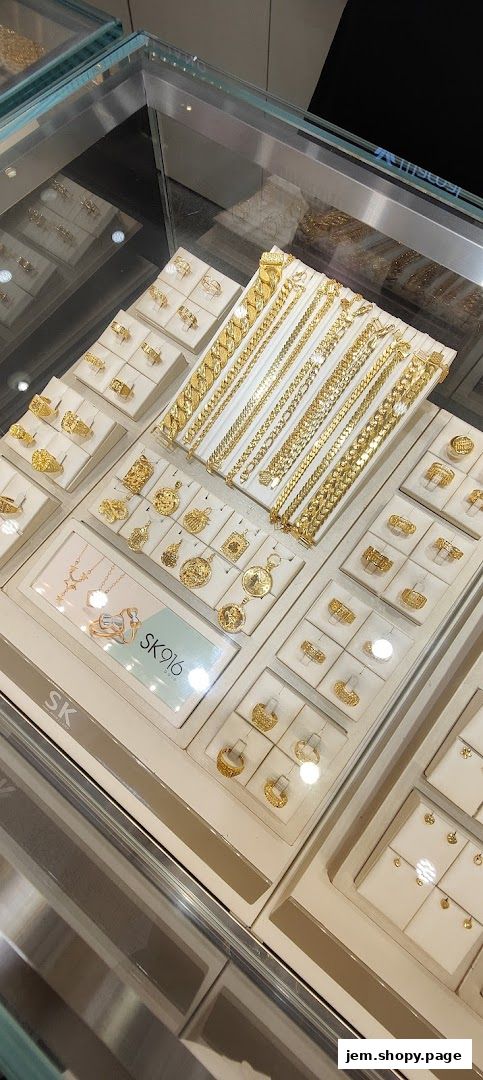 A display of various gold jewelry, including bracelets, rings, and pendants, in a retail store.