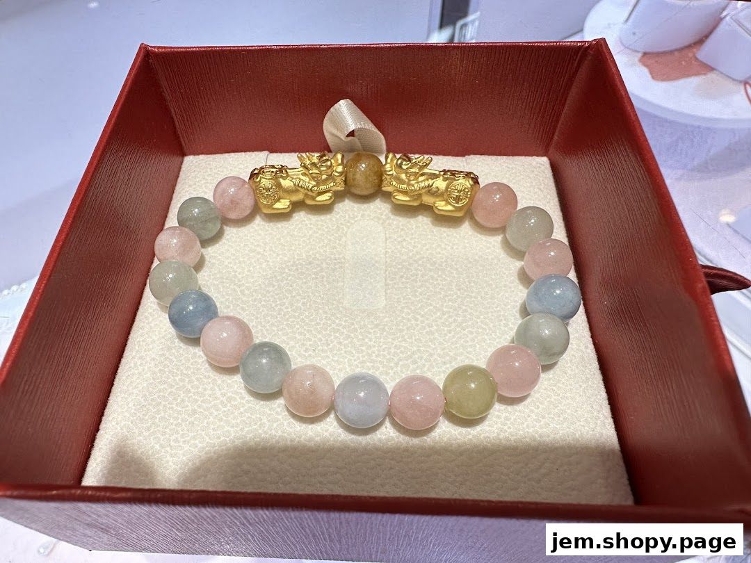 A delicate bracelet with pastel beads and gold charms in a red gift box.