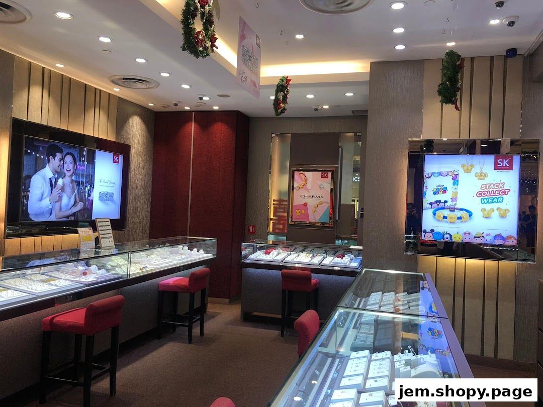 Interior of a jewelry store with display cases, screens, and festive decorations.