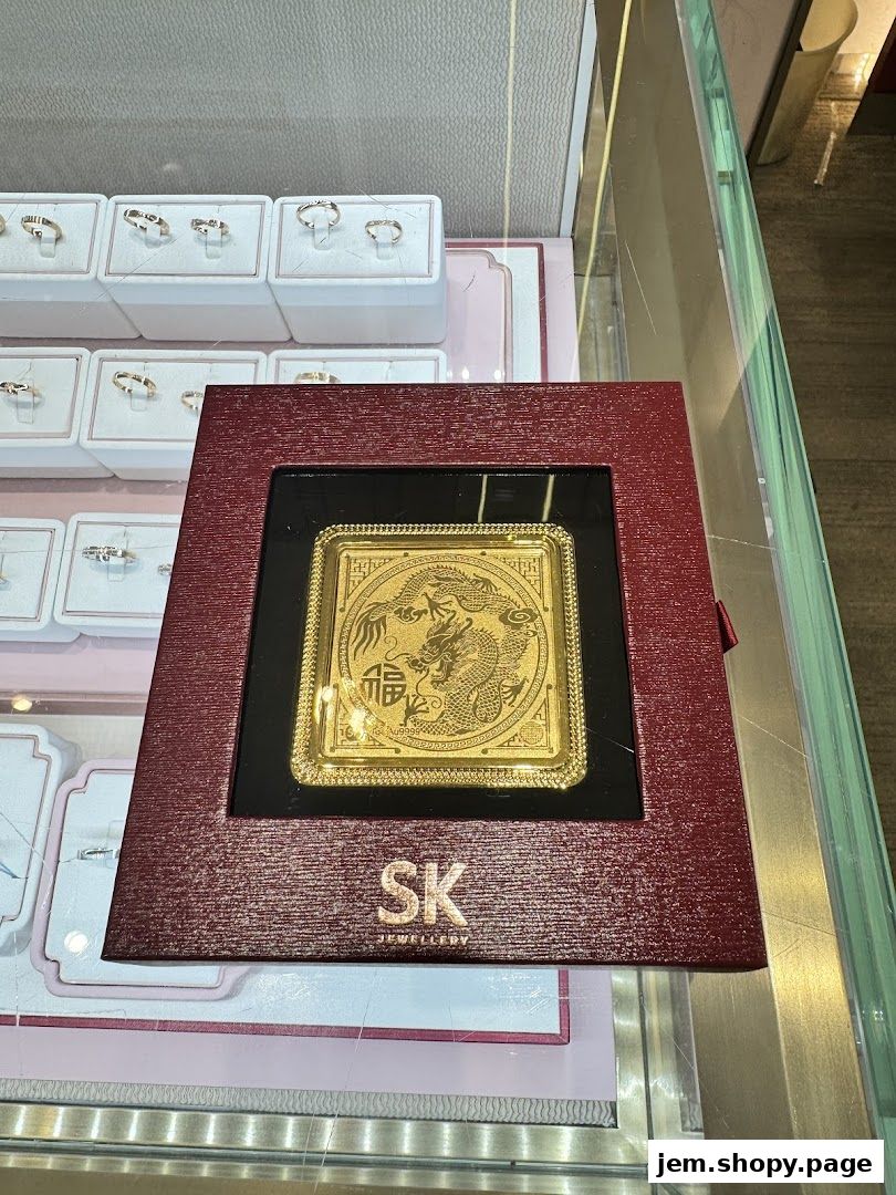 A display case at SK Jewellery featuring a gold ingot with dragon motif and various rings.