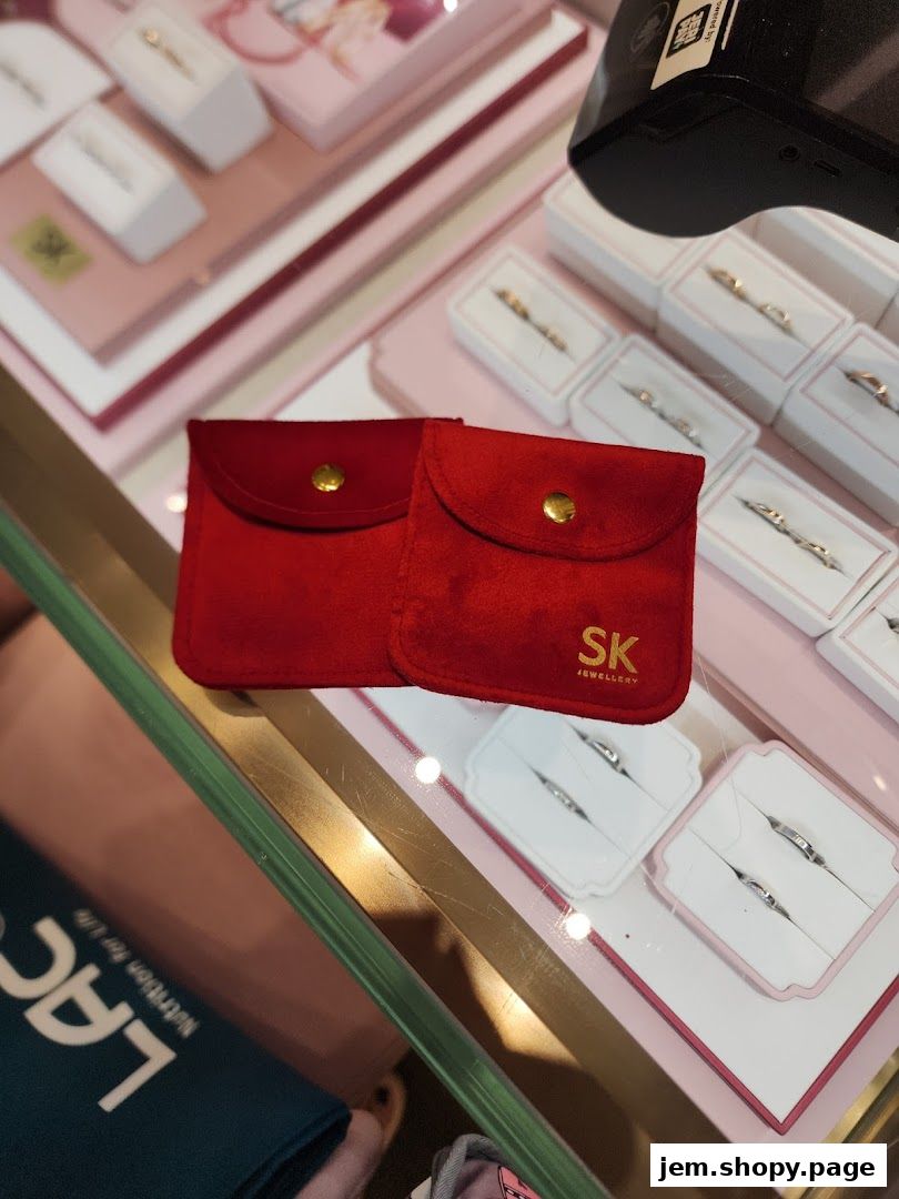 SK Jewellery display case with red pouches and rings in white boxes.