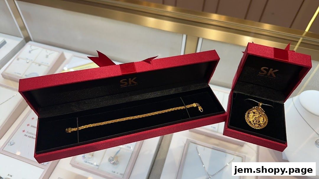 SK Jewellery Jem showcases a gold bracelet and pendant in elegant red gift boxes.