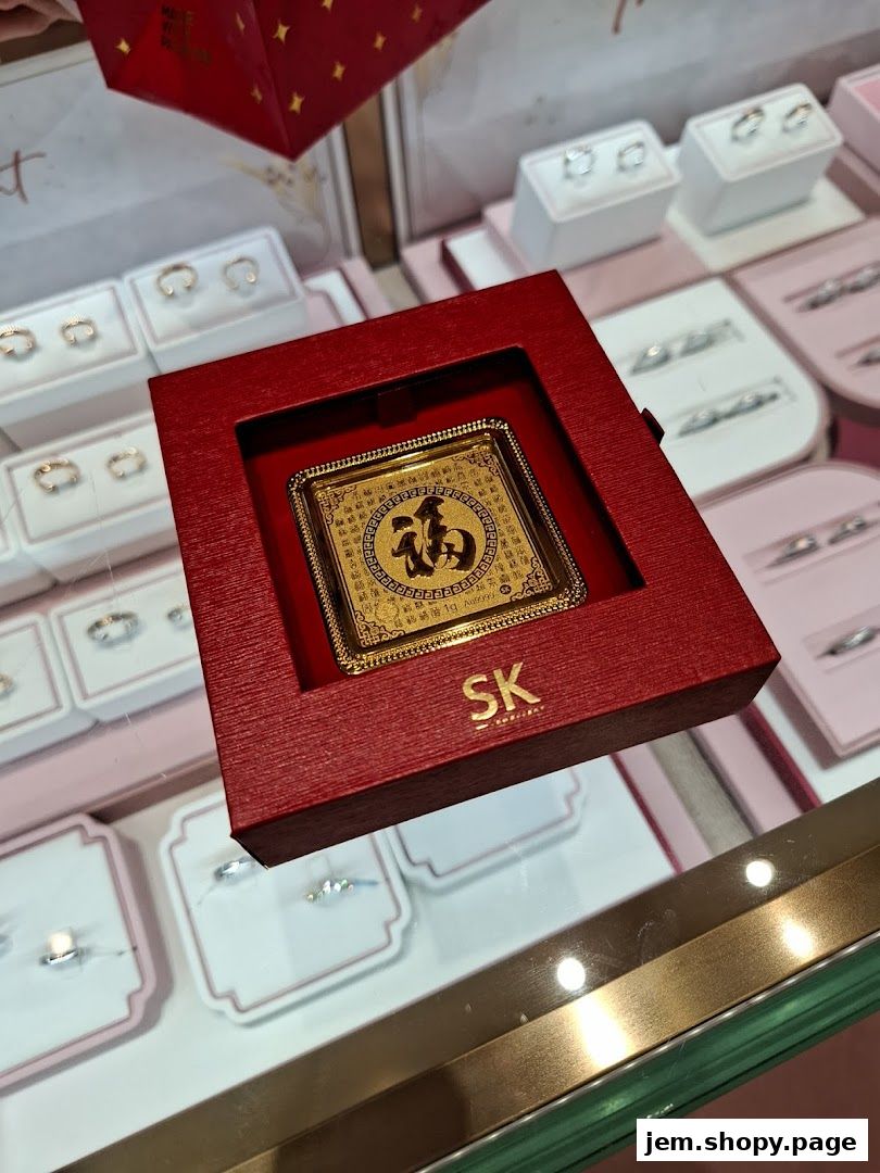 A red box displays a gold ingot with Chinese characters and SK Jewellery branding.