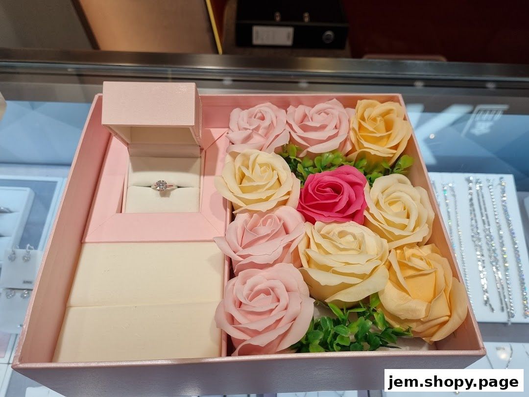 A jewelry box with a diamond ring and artificial roses, displayed in a shop.