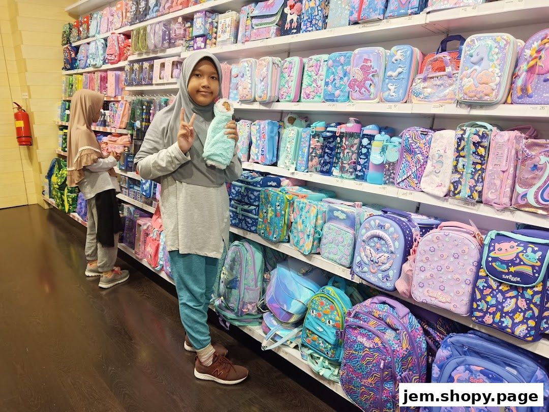 Two girls in a Smiggle store filled with colorful backpacks, pencil cases, and water bottles.