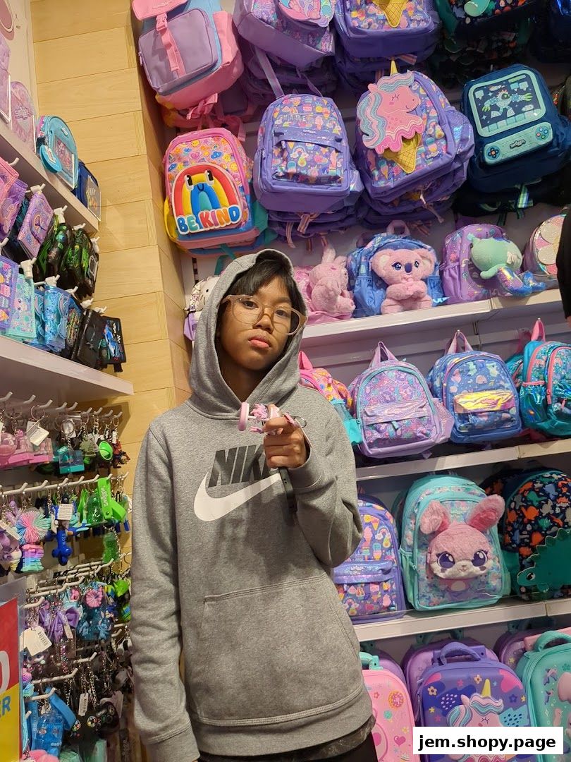 A person stands in a colorful shop filled with backpacks and accessories.
