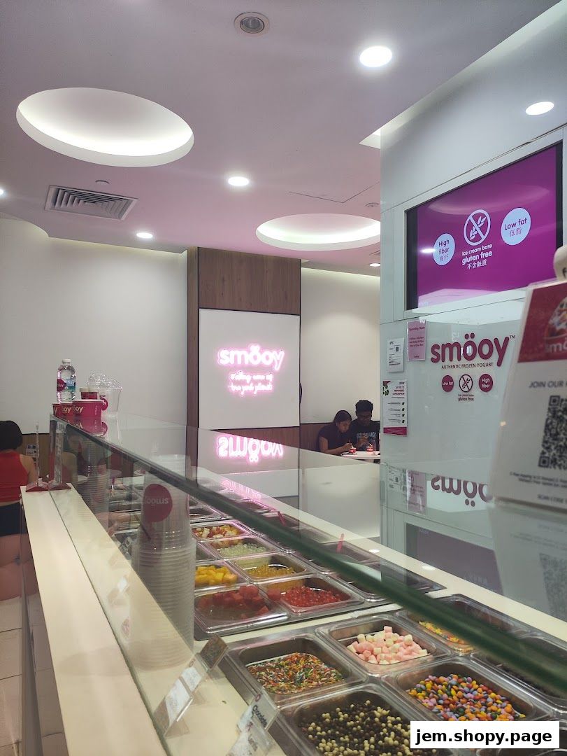 Interior of a frozen yogurt shop with various toppings displayed in containers.