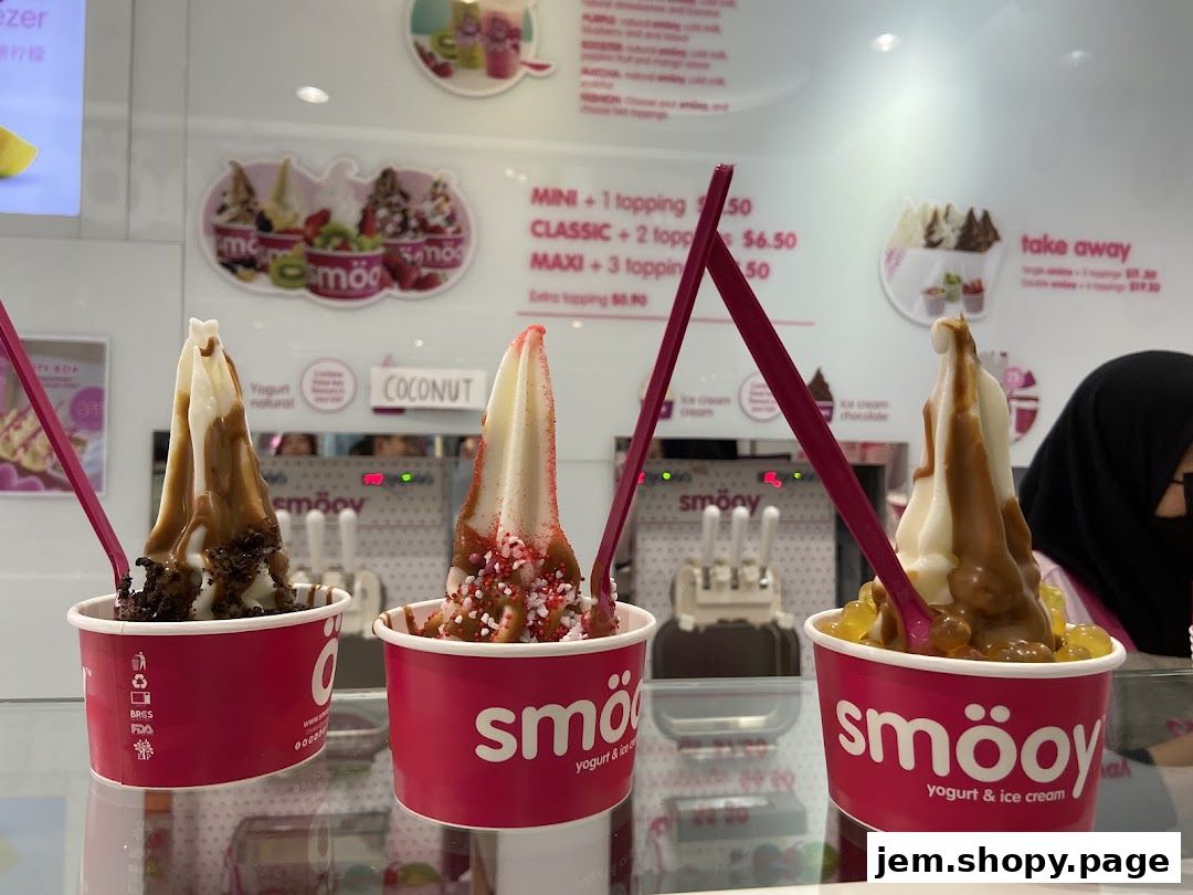 Three cups of frozen yogurt with toppings and sauces from smöoy.