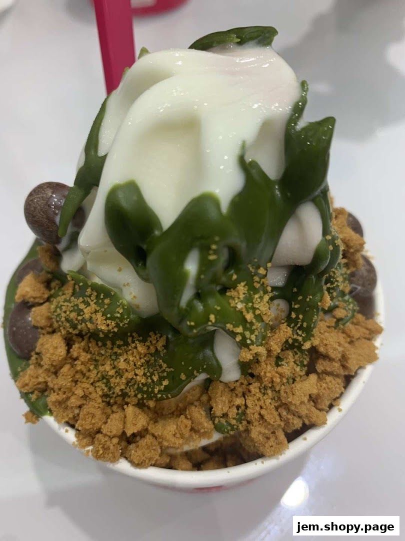 A delicious frozen yogurt dessert with green tea drizzle and cookie crumbles.