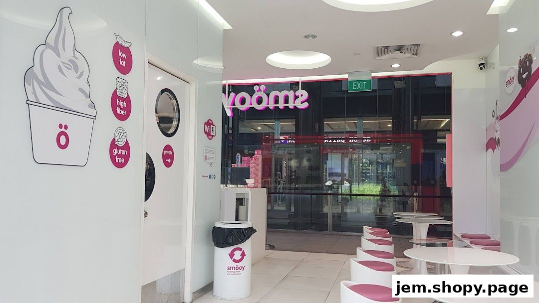 Interior view of a smöoy shop with seating, branding, and an exit sign.