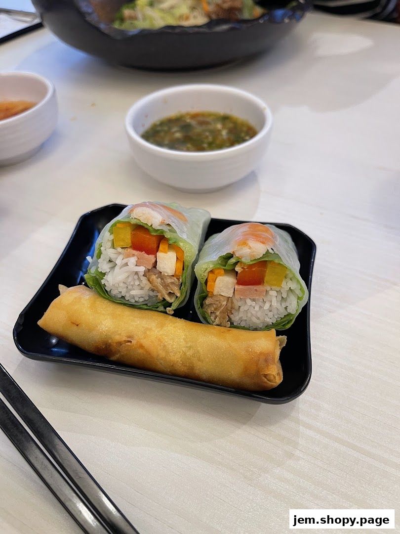 Fresh spring rolls and a crispy fried spring roll served with dipping sauce.