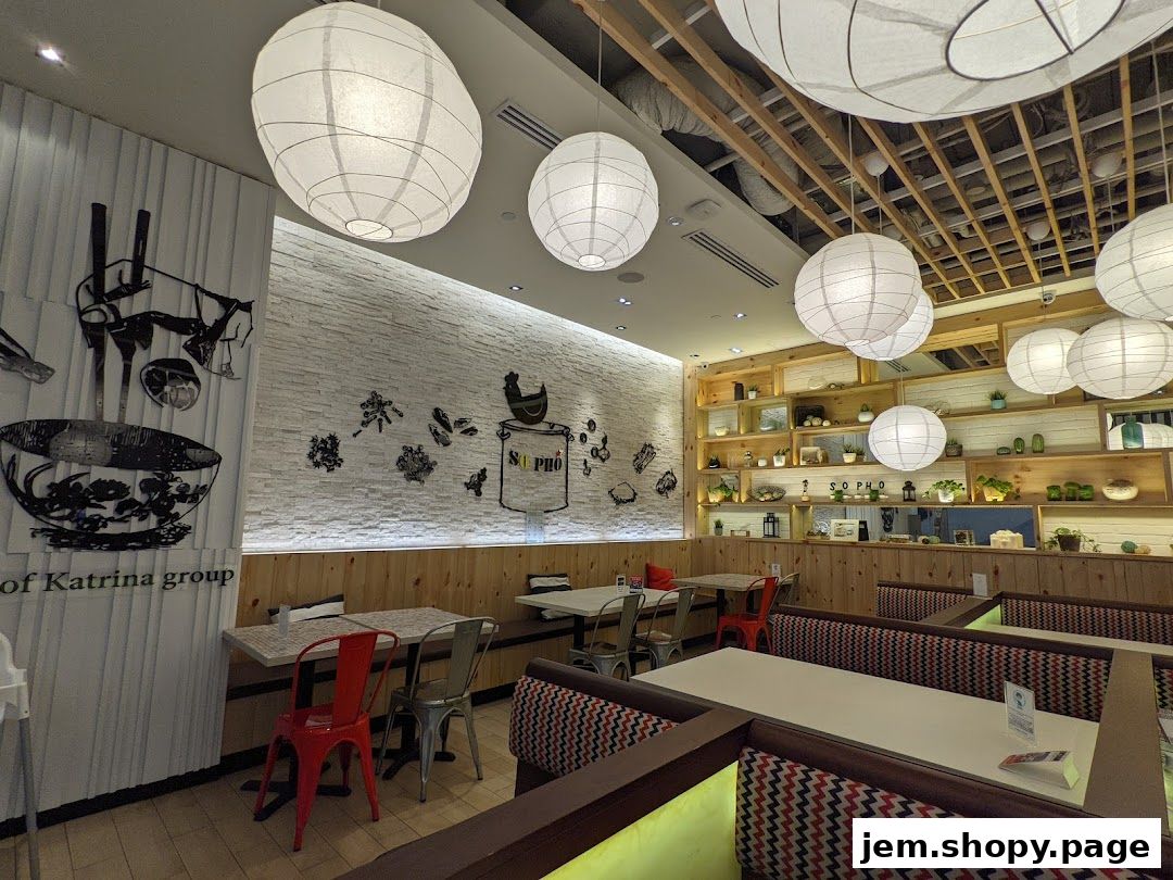 Interior of a modern Vietnamese restaurant with decorative lanterns and wooden shelves.