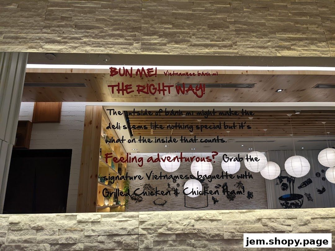 Text on a shop window advertising Vietnamese banh mi sandwiches.