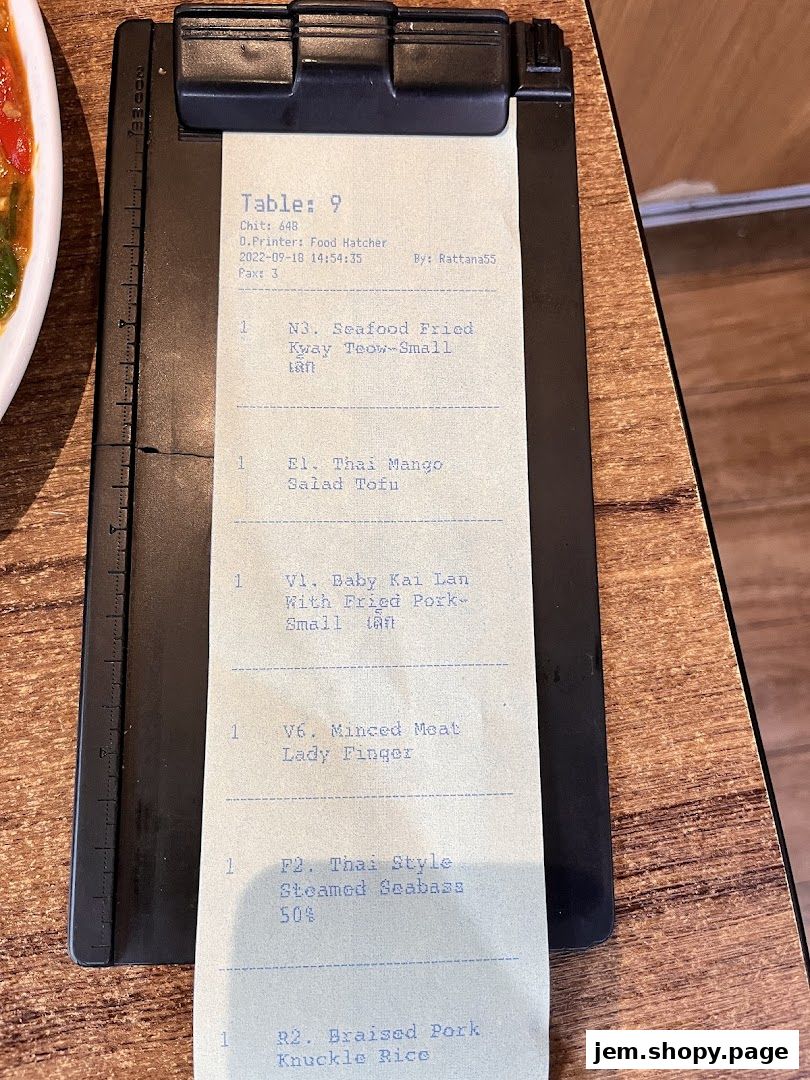 A receipt from Soi Thai Soi Nice JEM showing a table number and ordered food items.