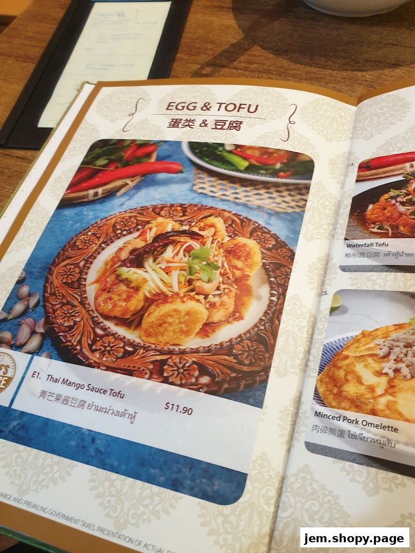 A menu page featuring Thai dishes, including tofu and omelette options.