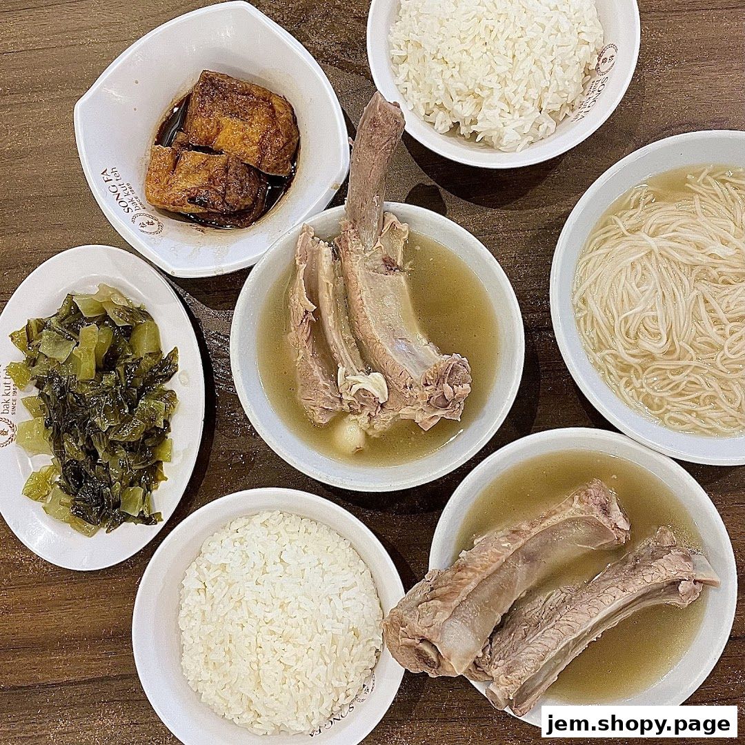 A spread of Song Fa Bak Kut Teh dishes including pork ribs, rice, noodles, and preserved vegetables.