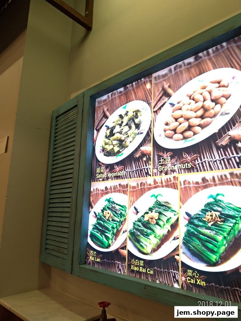 A display of food items including salted vegetables, groundnuts, and various green vegetables.