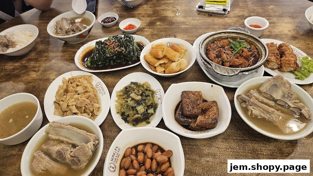 A spread of delicious Song Fa Bak Kut Teh dishes, including pork ribs, vegetables, and fried dough.