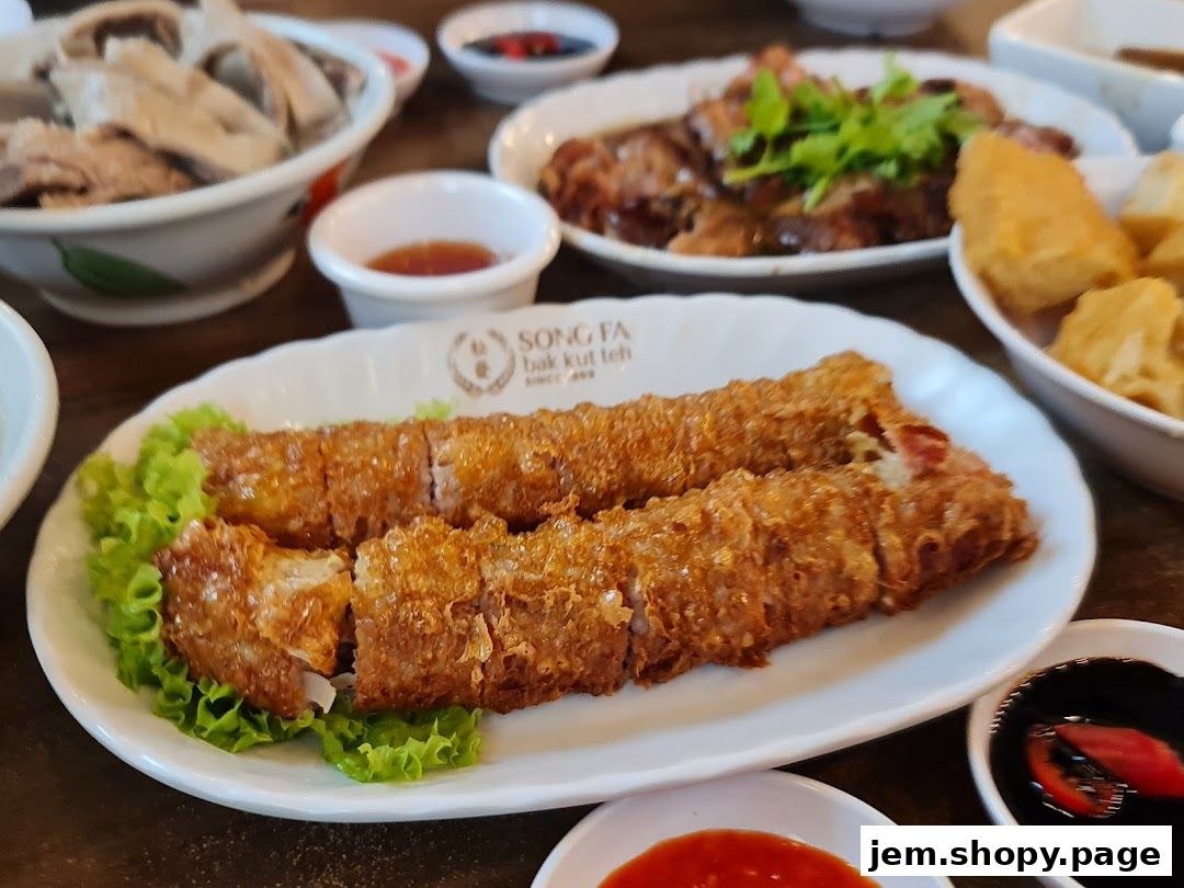 A close-up of crispy fried rolls served with lettuce and dipping sauces.
