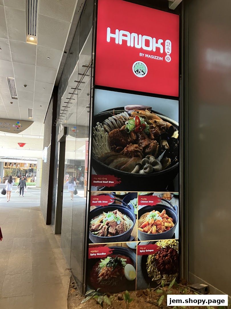 A display board showcasing various Korean stews, noodles, and octopus dishes from Hanok by Masizzim.