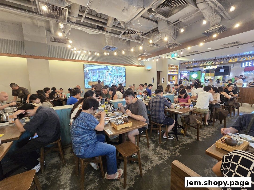 Diners enjoy meals at Song Fa Bak Kut Teh JEM, a bustling restaurant with a lively atmosphere.