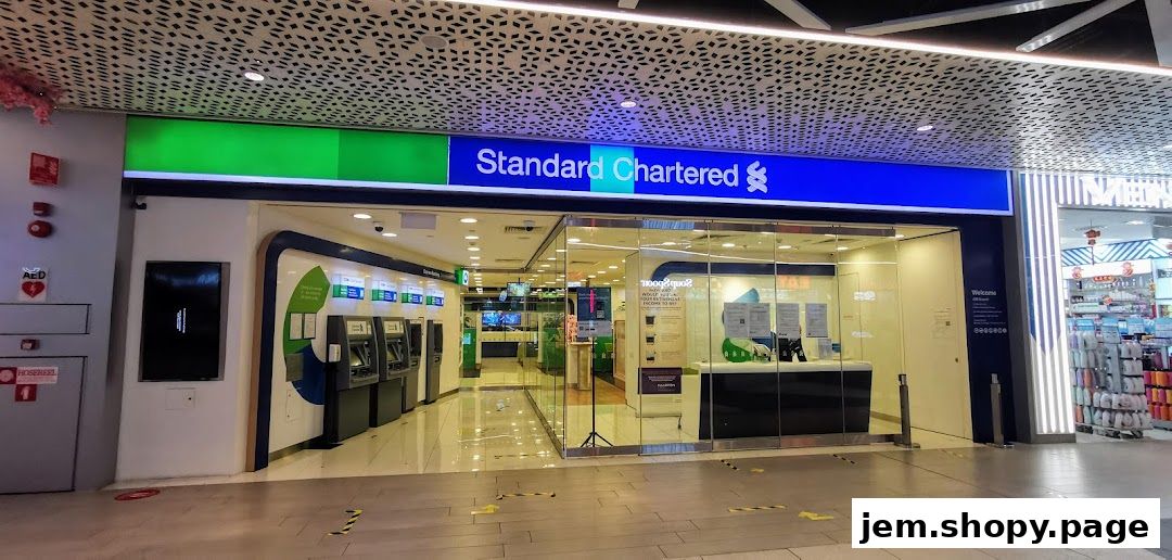 Exterior of a Standard Chartered Bank branch with ATMs and a service counter visible.