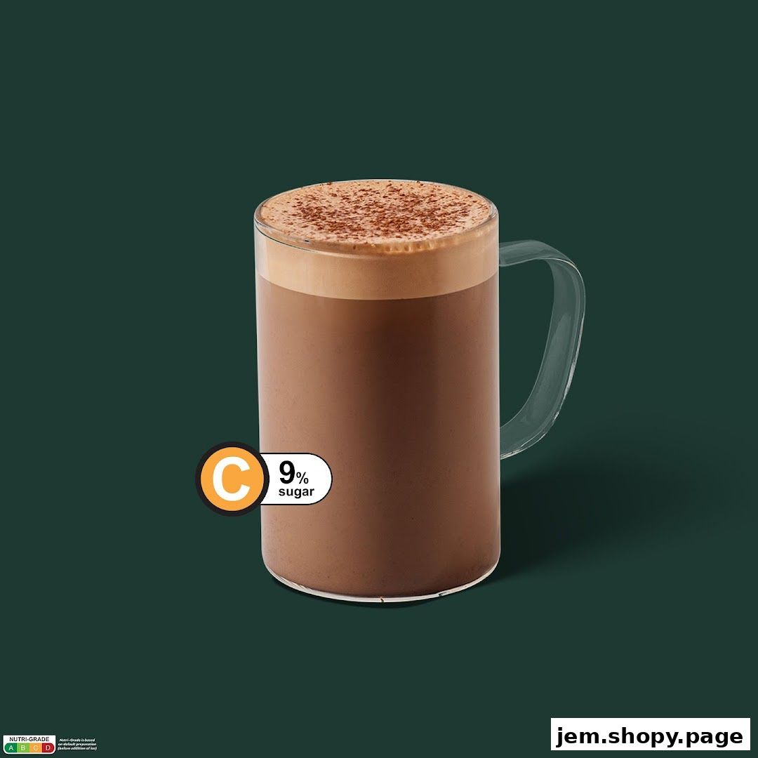 A tall glass mug filled with a chocolate beverage, topped with foam and cocoa powder.
