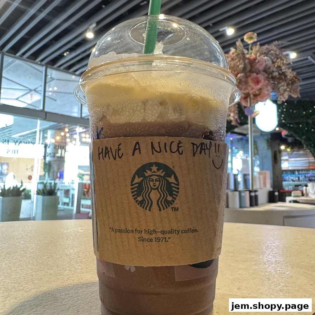 A Starbucks drink with a handwritten message and the iconic logo on its sleeve.