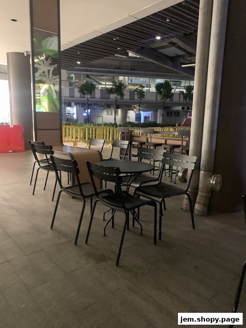 Outdoor seating area with tables and chairs at Starbucks.