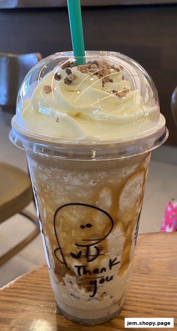 A Starbucks Frappuccino with whipped cream, caramel drizzle, and cookie crumbles.