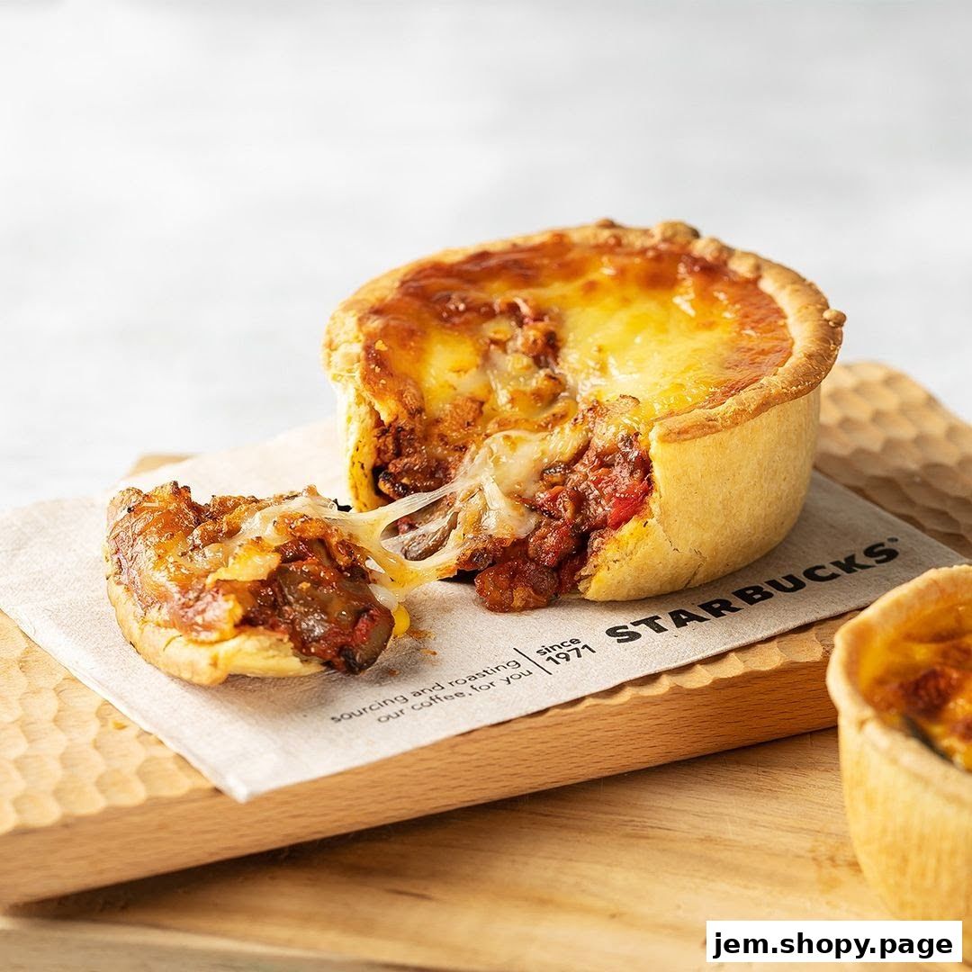 A savory pie with melted cheese and a hearty filling, served on a Starbucks napkin.