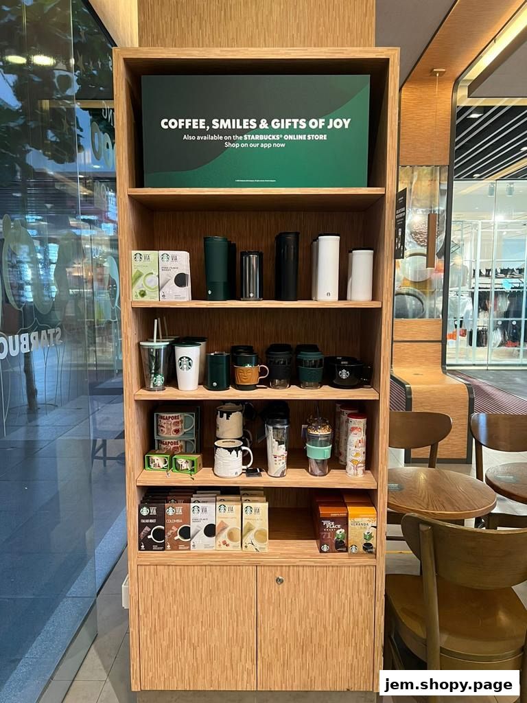 A display shelf in a Starbucks store showcasing coffee, mugs, and travel tumblers.