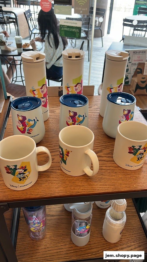 Starbucks merchandise featuring Disney characters, including mugs and tumblers.