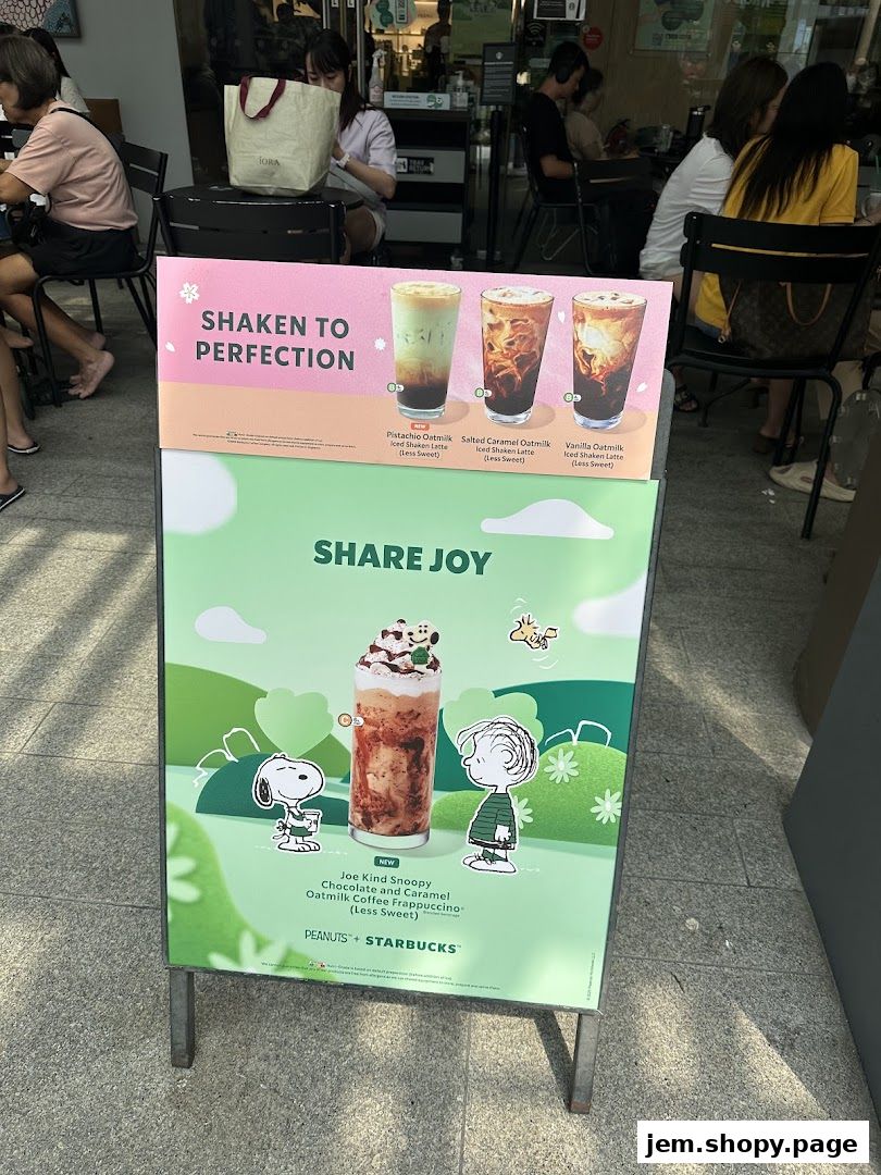 A Starbucks A-frame sign advertising new oatmilk lattes and a Snoopy-themed Frappuccino.