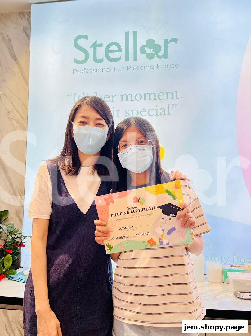 Two people, one holding a Stellar Piercing Certificate, stand in front of the shop's logo.