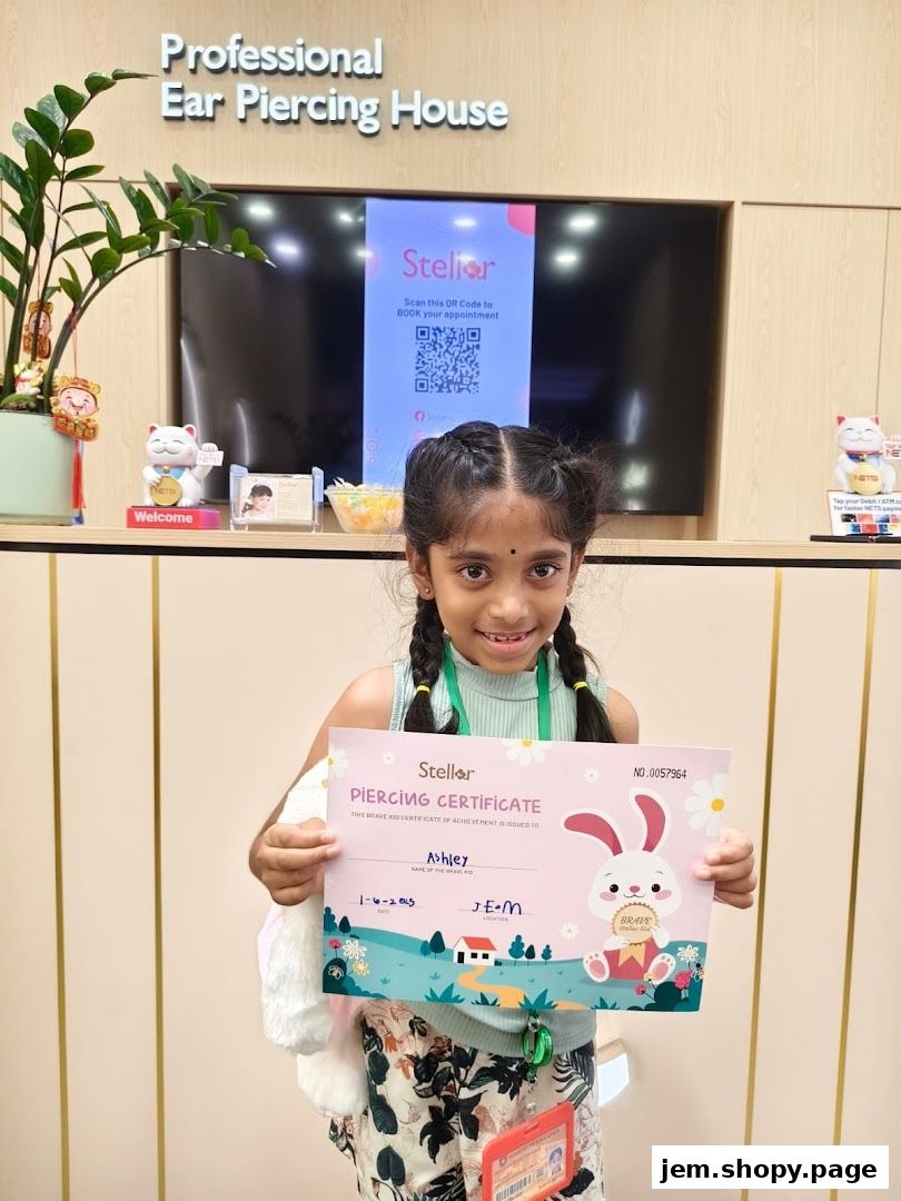 A young girl proudly holds a piercing certificate from Stellar Ear Piercing House.