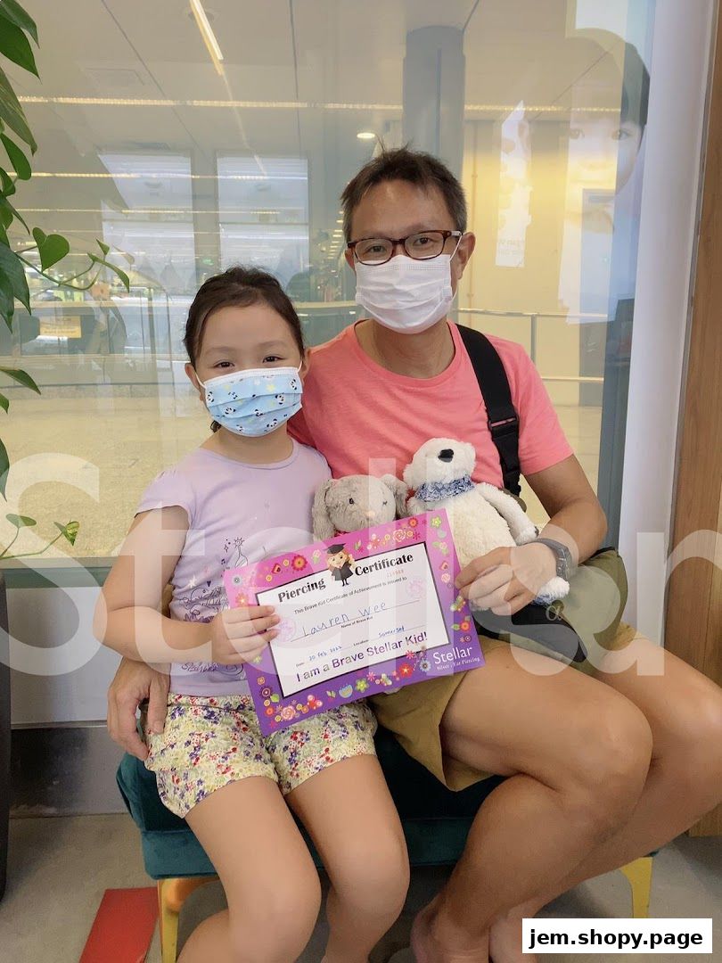 A father and daughter proudly display a piercing certificate, holding stuffed animals.