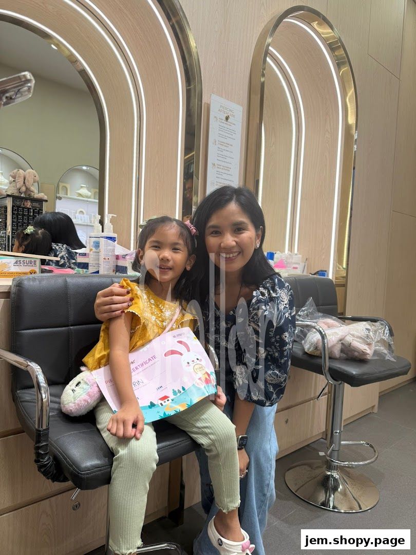 A woman and a child smiling, holding a piercing certificate in a jewelry shop.