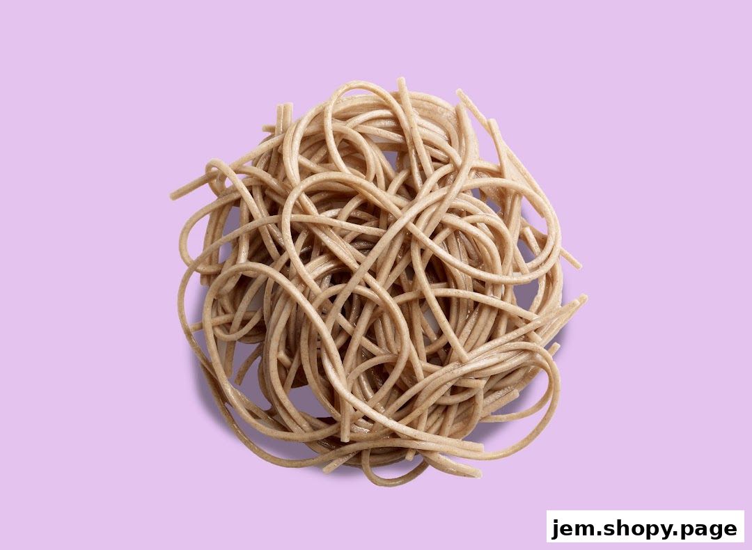 A pile of cooked soba noodles on a light purple background.