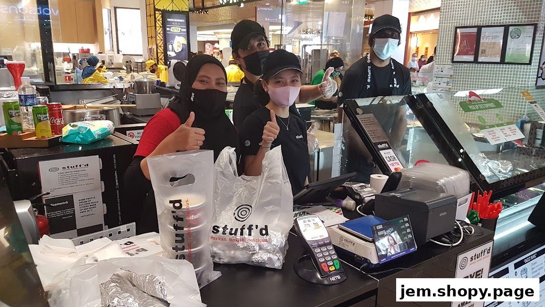 Staff at Stuff'd, a Mexican and Turkish food shop, giving thumbs up.