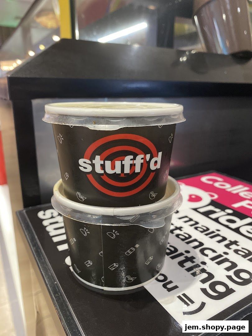 Two black takeaway containers with the Stuffd logo stacked on top of each other.