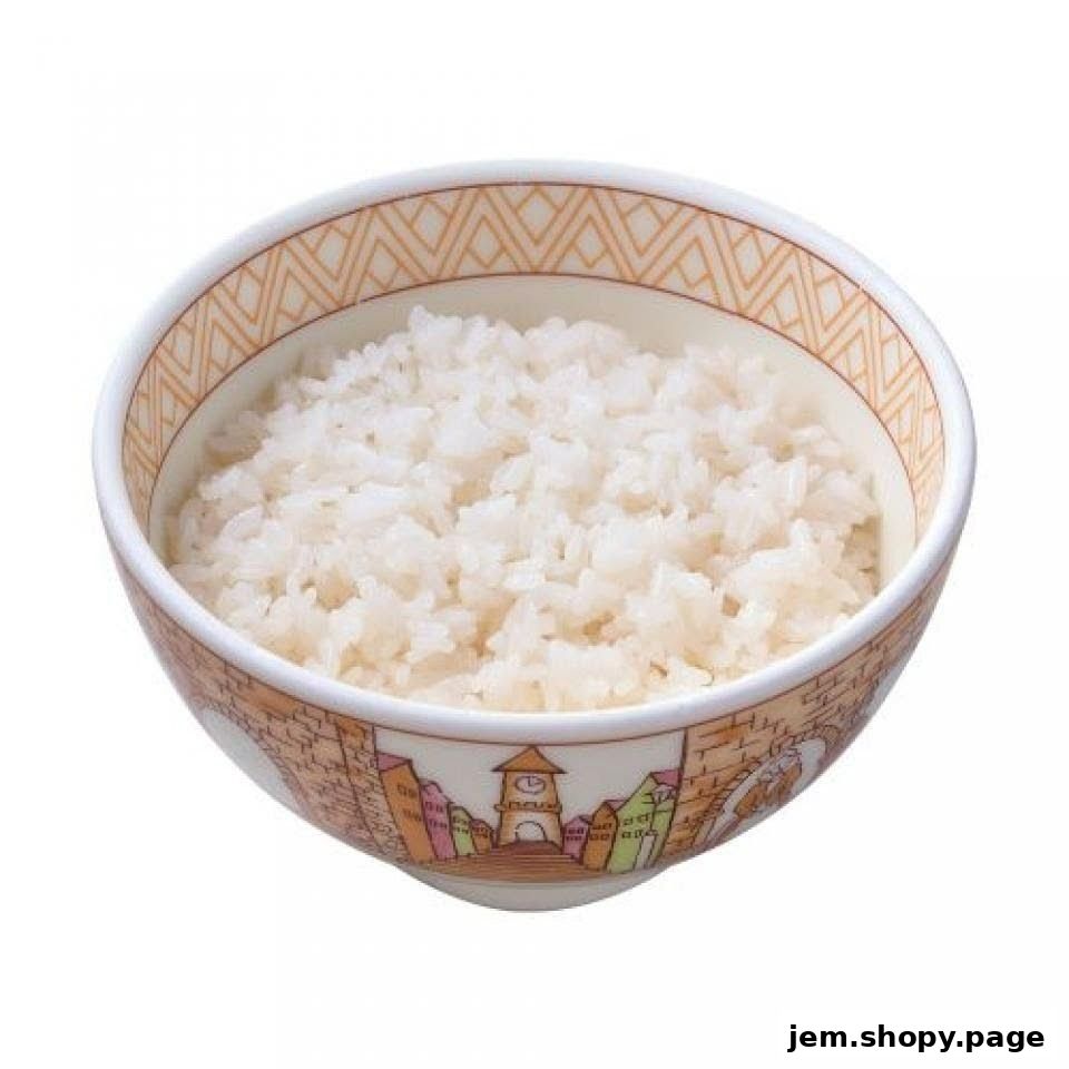 A bowl of fluffy white rice with a decorative rim featuring a town illustration.