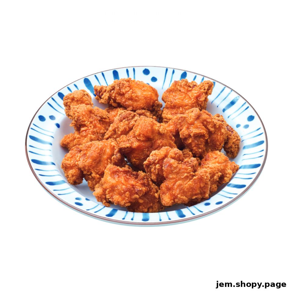 A plate of crispy, golden-brown fried chicken pieces on a decorative blue and white plate.