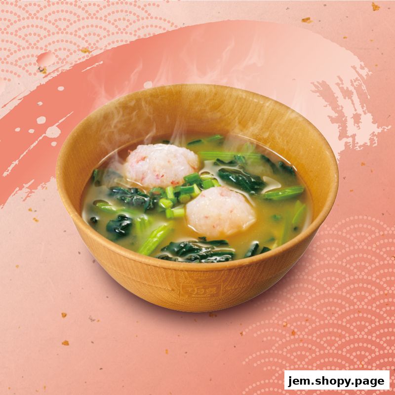 A steaming bowl of soup with meatballs and greens, presented in a wooden bowl.